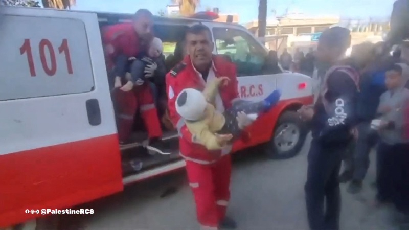 Members of the Palestine Red Crescent Society transport injured children to Al-Aqsa Hospital, in Deir Al-Balah