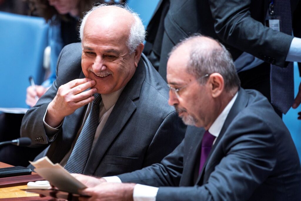 Palestinian Ambassador to the United Nations Riyad Mansour smiles next to Jordan's Deputy Prime Minister and Minister for Foreign Affairs and Expatriates Ayman Safadi after speaking to members of Security Council during a meeting to address the situation in the Middle East, at U.N. headquarters in New York City, New York, U.S., April 18, 2024. REUTERS/Eduardo Munoz