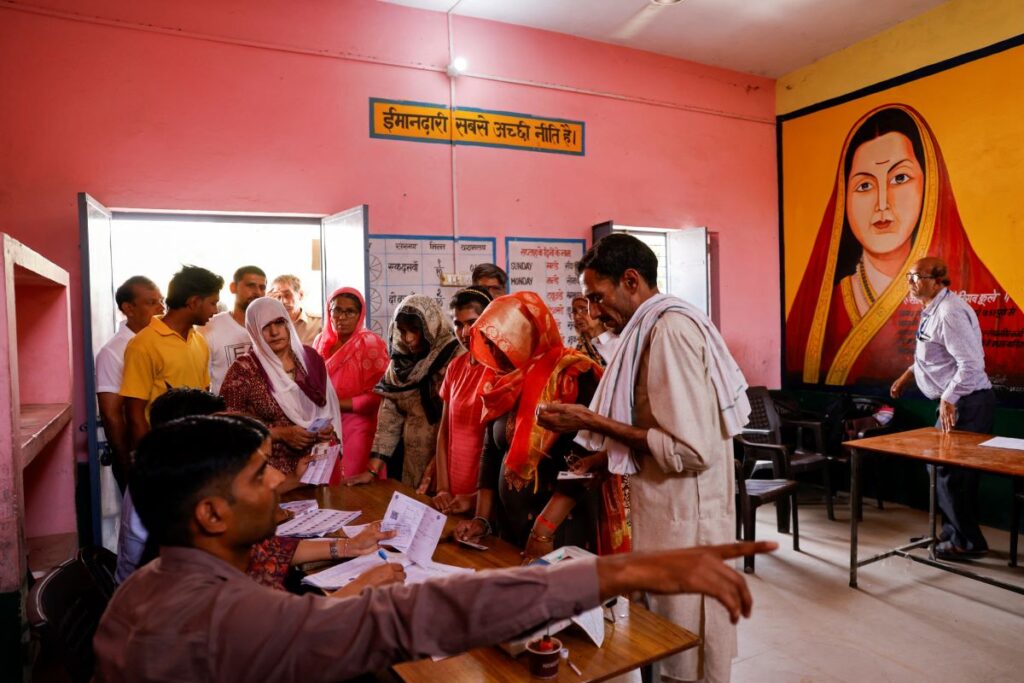 People stand inside a polling station during the first phase of the general election in the village Kutba Kutbi, Muzaffarnagar district in the northern Indian state of Uttar Pradesh, India, April 19, 2024. REUTERS/Anushree Fadnavis