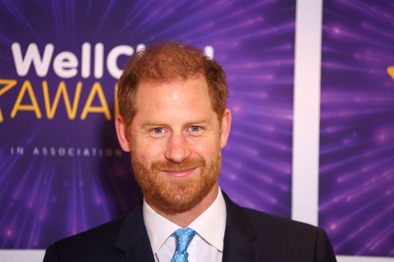 Prince Harry returned to Britain on Monday for a charity event for seriously ill children, appearing happy and playful as he chatted with the youngsters.