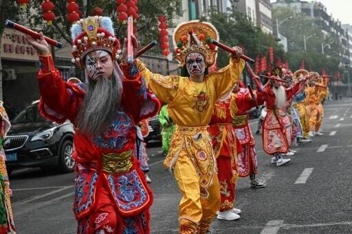 With painted faces and vivid costumes, 40 young dancers leap through the streets of Shantou in southern China to the sound of gongs and drums as hundreds of spectators watch.