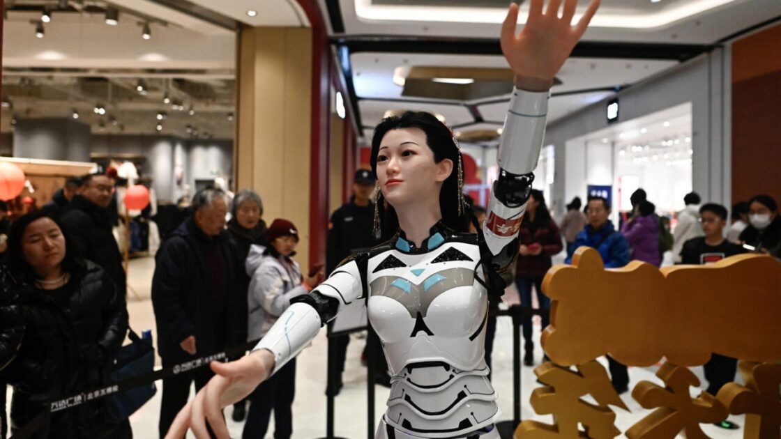 A humanoid robot gyrates to music at a shopping mall. part of an exhibition harnessing AI to enhance the biggest annual festival in China