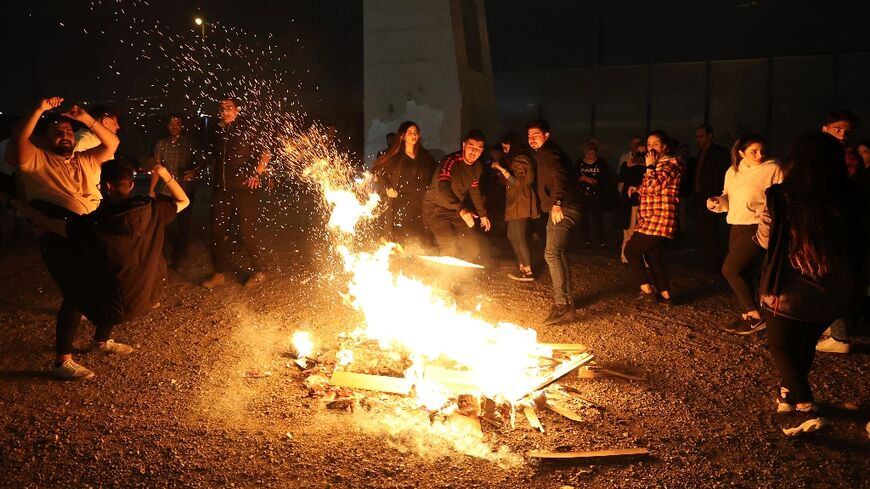 Iranians lit bonfires and jumped over them during the fire festival, an ancient tradition to purify themselves before the Persian New Year.