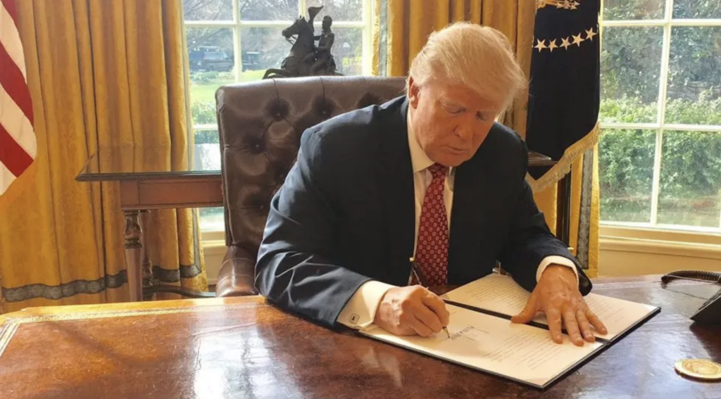 Trump signs executive order 13780, the second iteration of the travel ban.