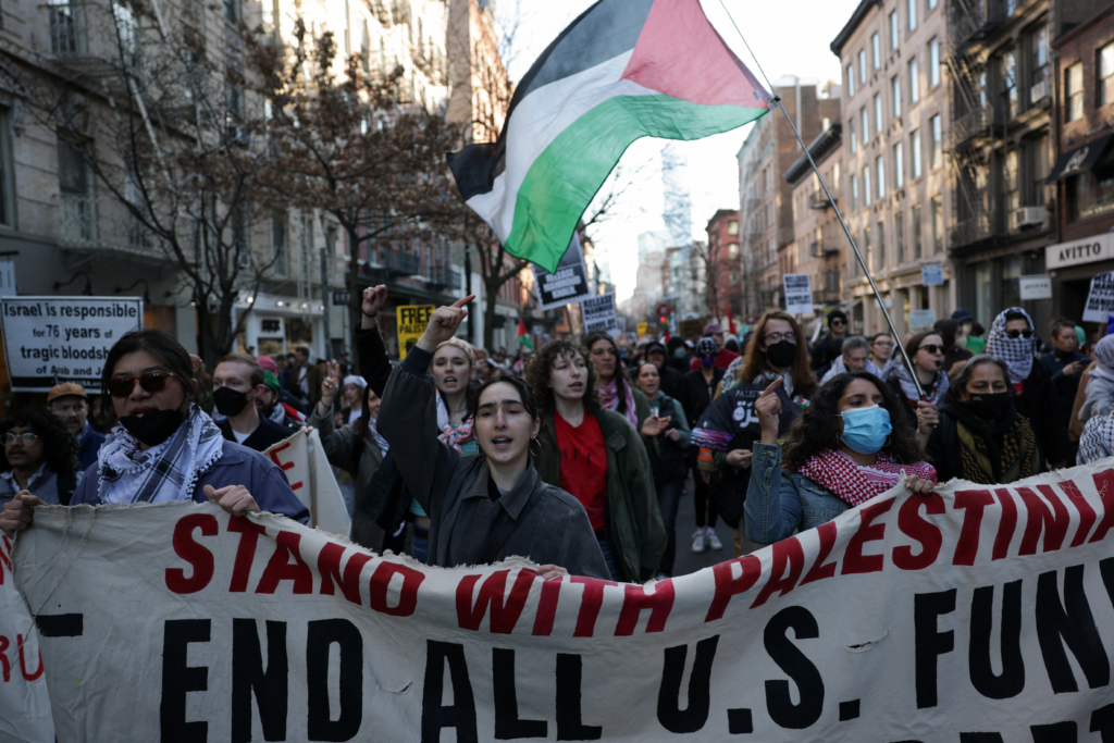 Demonstrators hold a banner as they march during a protest following the arrest by US immigration agents of Palestinian student protester Mahmoud Khalil at Columbia University, in New York City, U.S., March 10, 2025. REUTERS/Jeenah Moon
