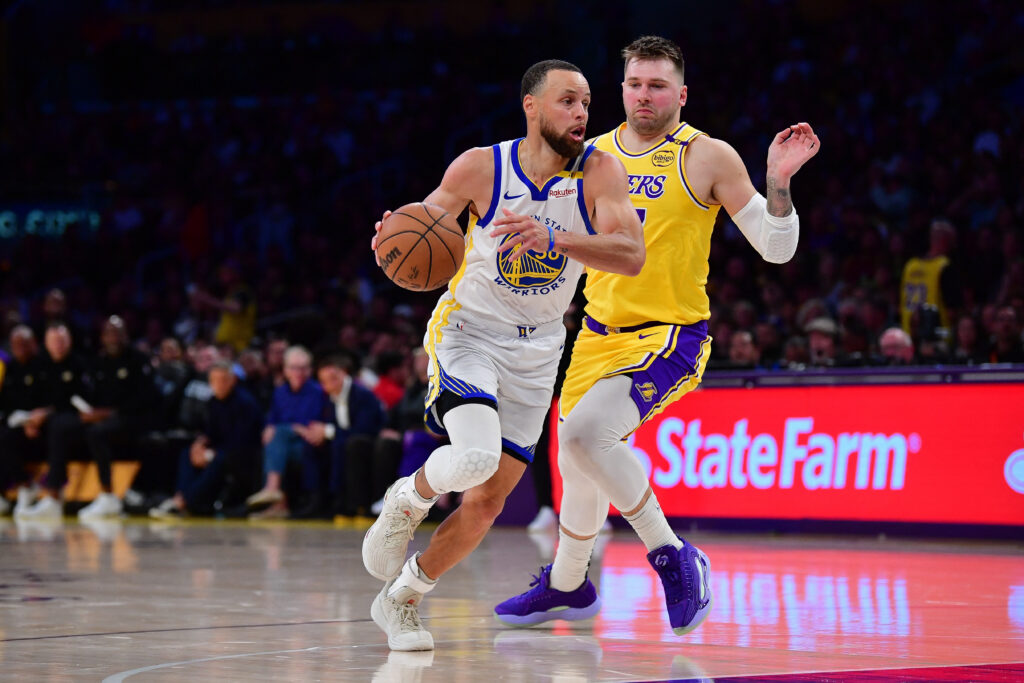 Apr 3, 2025; Los Angeles, California, USA; Golden State Warriors guard Stephen Curry (30) moves to the basket against Los Angeles Lakers guard Luka Doncic (77) during the second half at Crypto.com Arena. Mandatory Credit: Gary A. Vasquez-Imagn Images