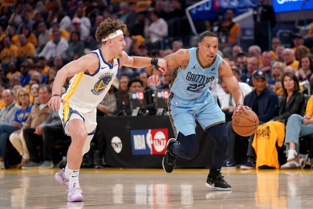 Apr 15, 2025; San Francisco, California, USA; Memphis Grizzlies guard Desmond Bane (22) dribbles past Golden State Warriors guard Brandin Podziemski (2) in the first quarter at the Chase Center. Mandatory Credit: Cary Edmondson-Imagn Images