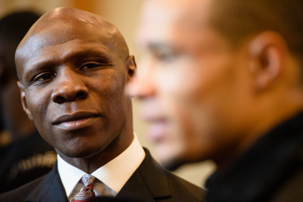 British boxer Chris Eubank Jr (R) and his father English, aka former boxing champion Chris Eubank Snr (L), are interviewed following a press conference in east London on December 10, 2015, promoting Eubank's upcoming non-title middleweight fight against Irish boxer Gary "Spike" O'Sullivan. AFP PHOTO / LEON NEAL (Photo by LEON NEAL / AFP)