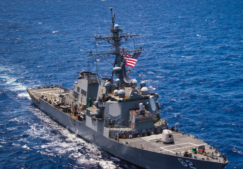 Iranian forces warned a US destroyer to stay out of waters claimed by Iran, an interaction a US official said was 